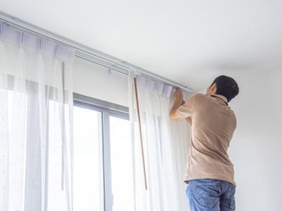 young-man-installing-blind-curtains-window-renovate-inside-house_73740-428 (1)
